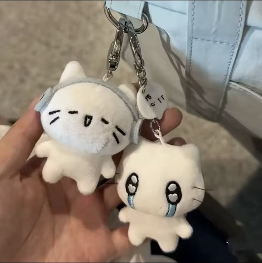 Cute plush kitten keychains attached to a handbag