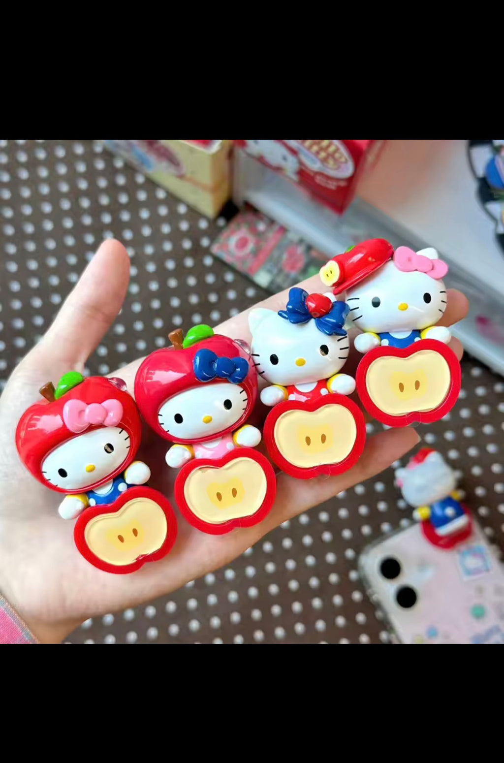 Hello Kitty Apple Party collectible figures shown in hand