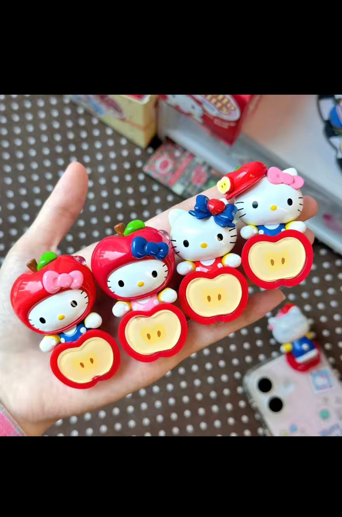 Hello Kitty Apple Party collectible figures shown in hand