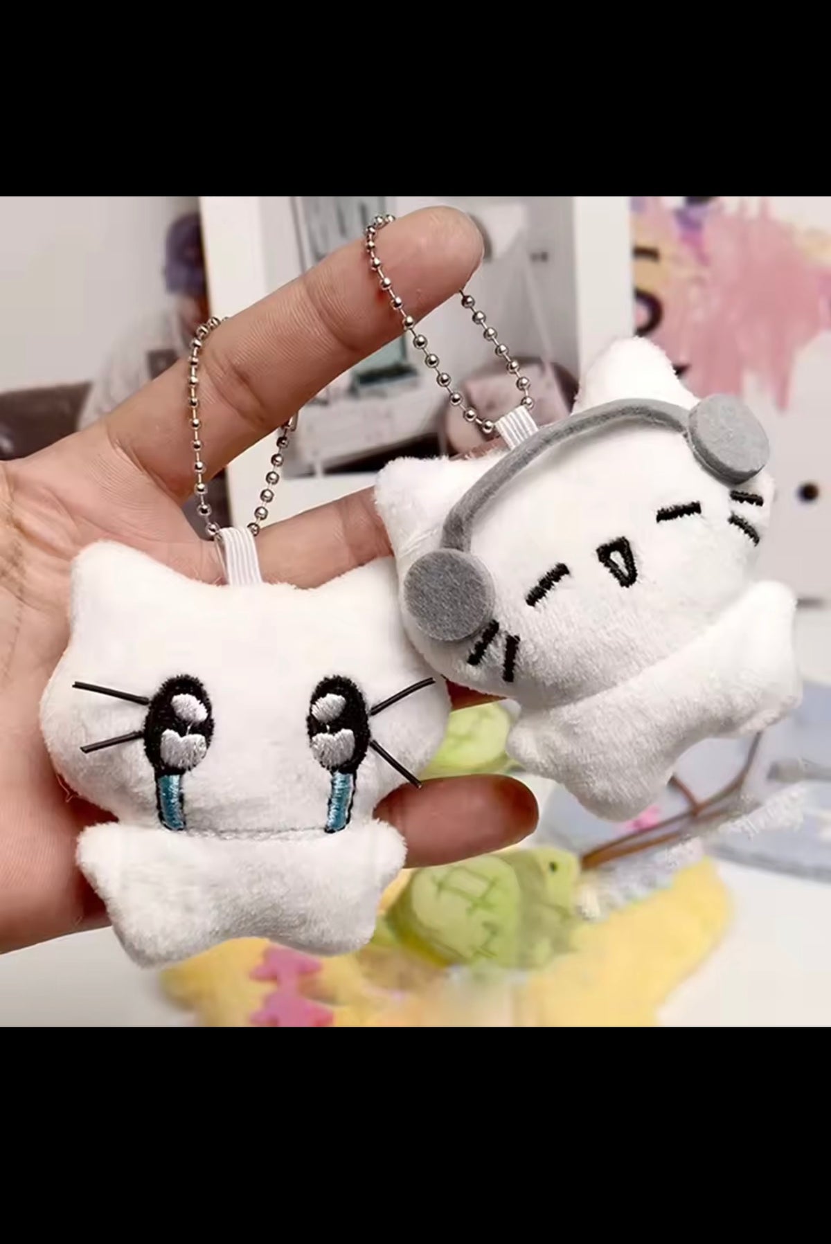 Kitten plush keychains held in hand